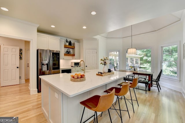7920 Tintern Trce Unit 298, Duluth, GA 30097 - kitchen with stainless steel refrigerator with ice dispenser, a sink, open shelves, baseboards, and light wood finished floors