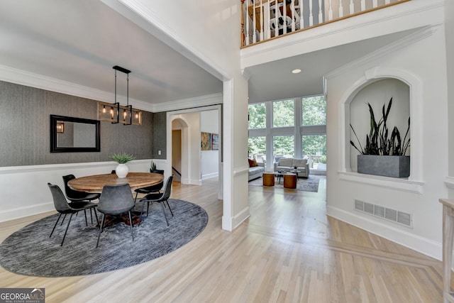 7920 Tintern Trce Unit 298, Duluth, GA 30097 - dining space with arched walkways, baseboards, ornamental molding, wallpapered walls, and a chandelier