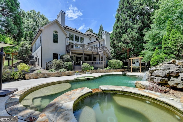 7920 Tintern Trce Unit 298, Duluth, GA 30097 - view of swimming pool featuring stairs, a pool with connected hot tub, and a wooden deck