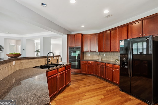 2840 Brookford Ln SW, South Fulton, GA 30331 - kitchen featuring black appliances, a sink, reddish brown cabinets, light wood-style flooring, and recessed lighting