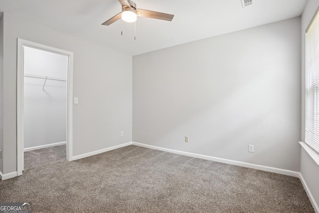 2840 Brookford Ln SW, South Fulton, GA 30331 - unfurnished bedroom with carpet flooring, a walk in closet, and baseboards