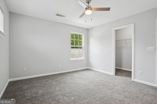 2840 Brookford Ln SW, South Fulton, GA 30331 - unfurnished bedroom with a walk in closet, carpet, and baseboards