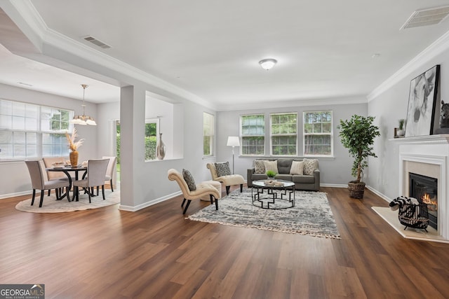2840 Brookford Ln SW, South Fulton, GA 30331 - living area with plenty of natural light, a glass covered fireplace, ornamental molding, dark wood-type flooring, and baseboards