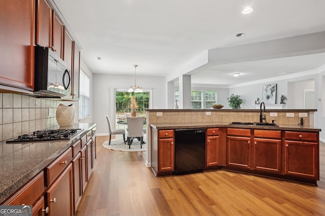 2840 Brookford Ln SW, South Fulton, GA 30331 - kitchen with dishwasher, gas stovetop, light wood-style floors, a sink, and decorative backsplash