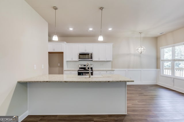 6413 River Plantation Dr, Lula, GA 30554 - kitchen featuring appliances with stainless steel finishes, white cabinets, light stone countertops, dark wood finished floors, and tasteful backsplash