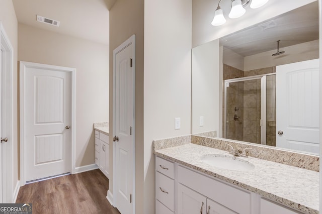 6413 River Plantation Dr, Lula, GA 30554 - full bathroom with vanity, a shower stall, and wood finished floors