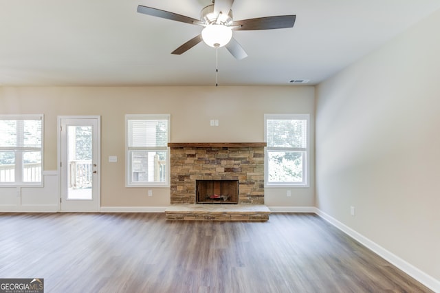 6413 River Plantation Dr, Lula, GA 30554 - unfurnished living room with wood finished floors, ceiling fan, a fireplace, and plenty of natural light