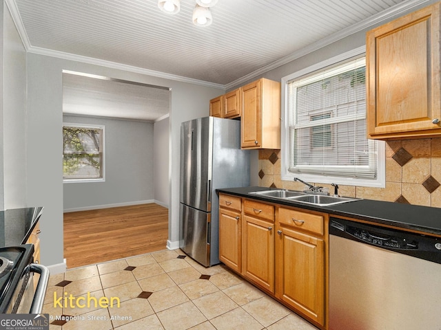 269 Magnolia St, Athens, GA 30606 - kitchen with appliances with stainless steel finishes, dark countertops, light tile patterned flooring, and crown molding