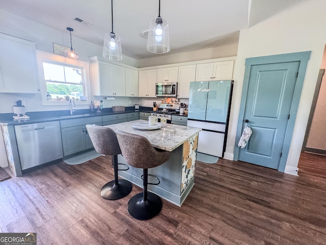 2980 Hd Atha Rd, Covington, GA 30014 - kitchen featuring appliances with stainless steel finishes, a sink, white cabinets, and dark wood-style floors