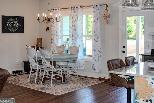 2980 Hd Atha Rd, Covington, GA 30014 - dining space with a chandelier, wood finished floors, healthy amount of natural light, and baseboards