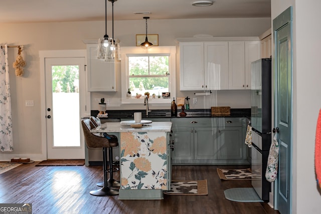 2980 Hd Atha Rd, Covington, GA 30014 - kitchen with freestanding refrigerator, healthy amount of natural light, a sink, and dark wood-type flooring