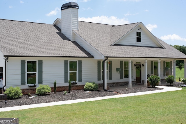 2980 Hd Atha Rd, Covington, GA 30014 - view of front of property with a shingled roof, a porch, a front yard, and a chimney