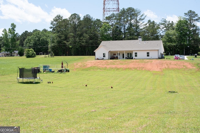 2980 Hd Atha Rd, Covington, GA 30014 - view of green lawn with a trampoline and view of wooded area