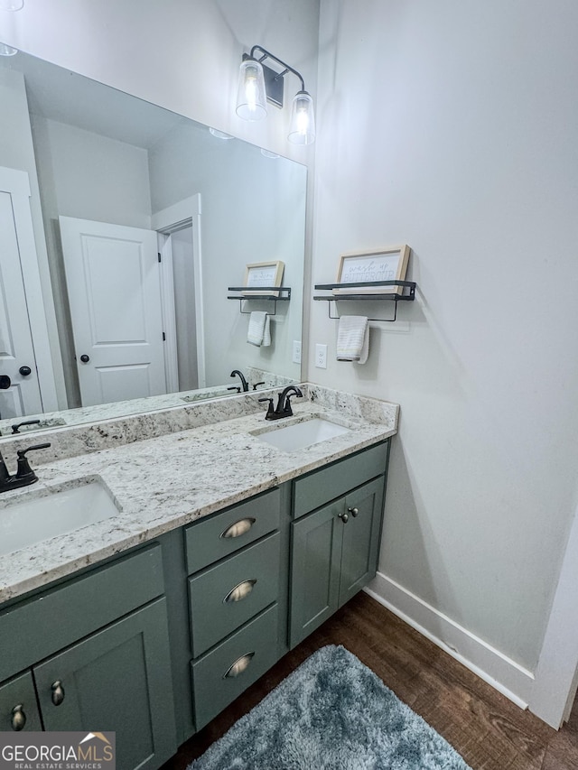 2980 Hd Atha Rd, Covington, GA 30014 - full bathroom with double vanity, wood finished floors, and baseboards