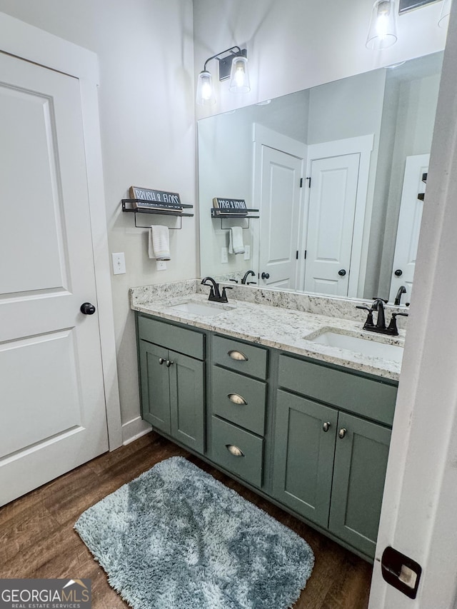 2980 Hd Atha Rd, Covington, GA 30014 - full bathroom featuring double vanity, wood finished floors, and baseboards