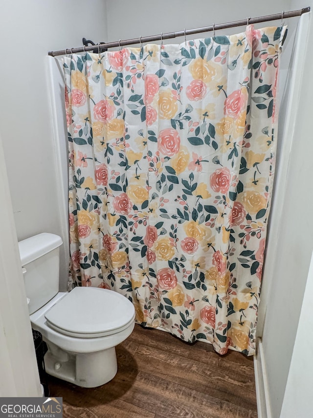 2980 Hd Atha Rd, Covington, GA 30014 - full bathroom with wood finished floors, toilet, and a shower with curtain