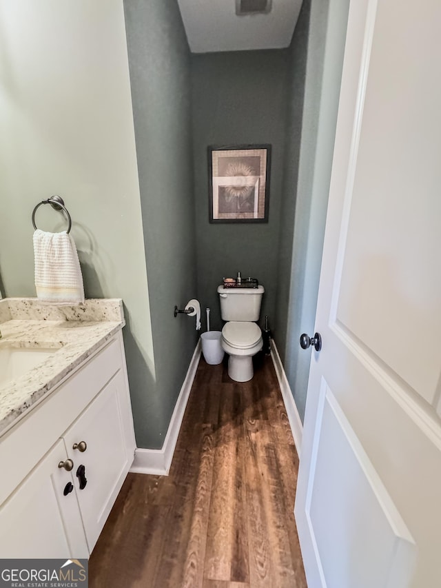 2980 Hd Atha Rd, Covington, GA 30014 - bathroom featuring vanity, wood finished floors, toilet, and baseboards