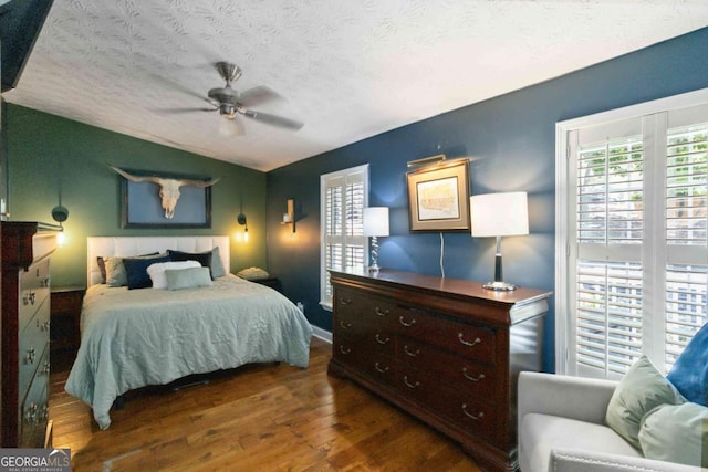 6551 Bermuda Ln, Flowery Branch, GA 30542 - bedroom with wood finished floors, a textured ceiling, ceiling fan, and lofted ceiling