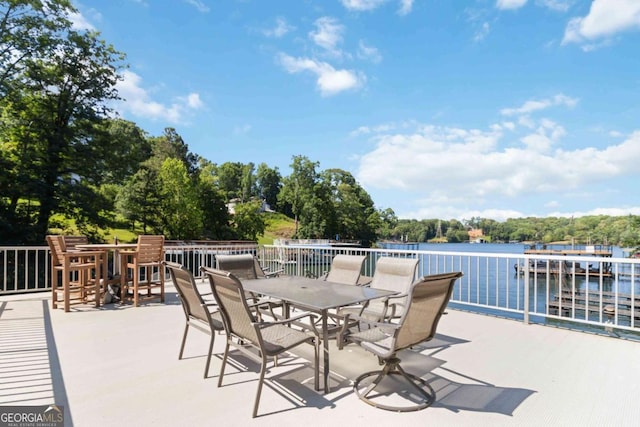 6551 Bermuda Ln, Flowery Branch, GA 30542 - view of patio / terrace featuring a water view, outdoor dining area, and view of wooded area