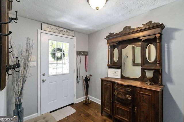 6551 Bermuda Ln, Flowery Branch, GA 30542 - entrance foyer featuring dark wood-style floors, baseboards, and a textured ceiling