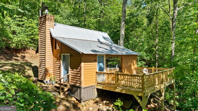 382 Highland Rd, Ellijay, GA 30540 - view of front of property featuring a chimney, metal roof, a deck, and a wooded view