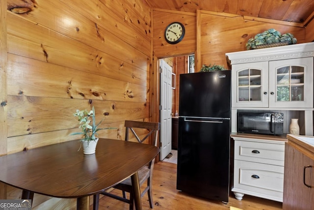 382 Highland Rd, Ellijay, GA 30540 - dining room featuring light wood-type flooring, wood walls, lofted ceiling, and wooden ceiling