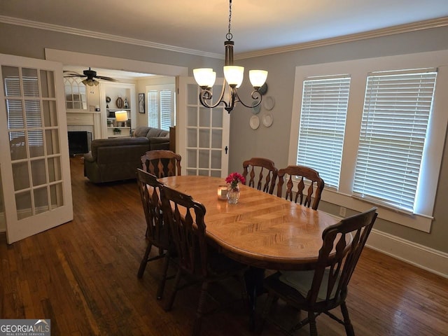 142 Griffin Dr, Carrollton, GA 30117 - dining area featuring wood finished floors, ornamental molding, a chandelier, a ceiling fan, and a fireplace