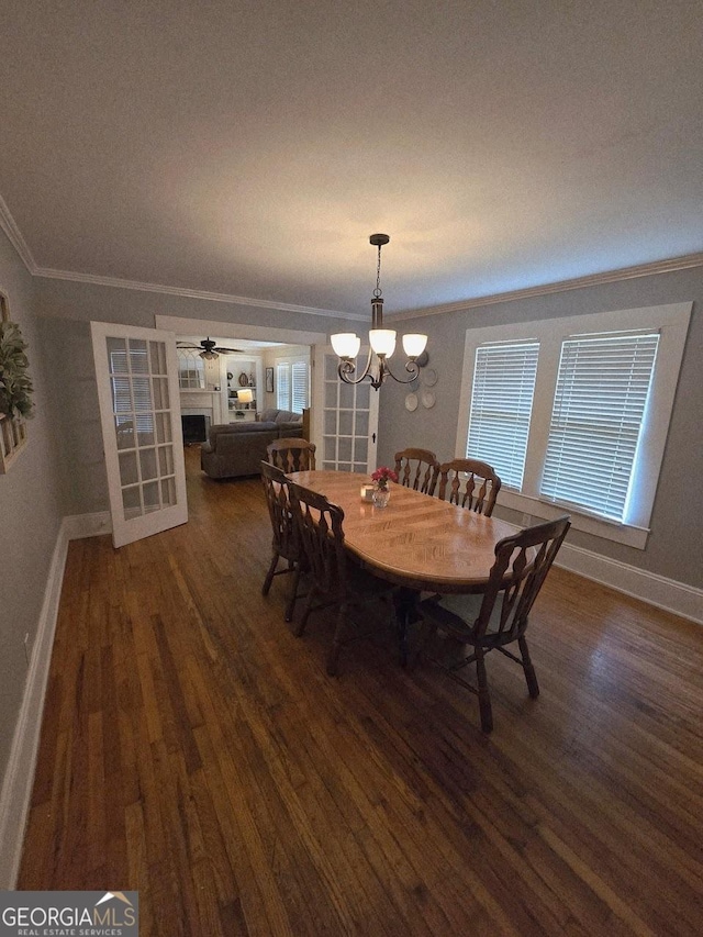 142 Griffin Dr, Carrollton, GA 30117 - dining area featuring crown molding, dark wood-style flooring, and a chandelier