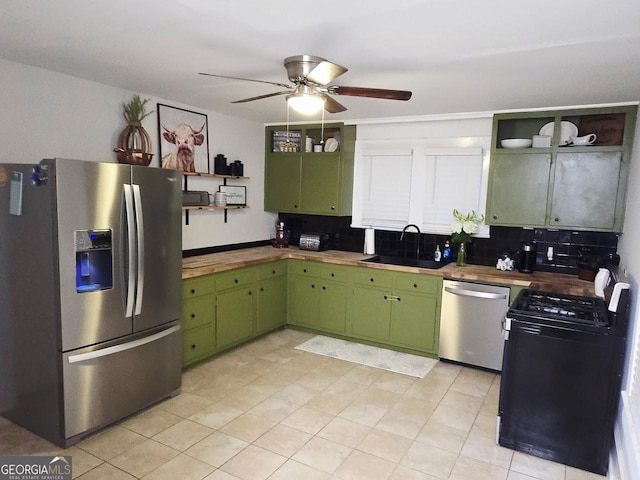 142 Griffin Dr, Carrollton, GA 30117 - kitchen with stainless steel appliances, green cabinetry, open shelves, a ceiling fan, and decorative backsplash