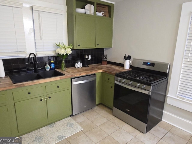 142 Griffin Dr, Carrollton, GA 30117 - kitchen with appliances with stainless steel finishes, green cabinets, butcher block counters, decorative backsplash, and light tile patterned floors