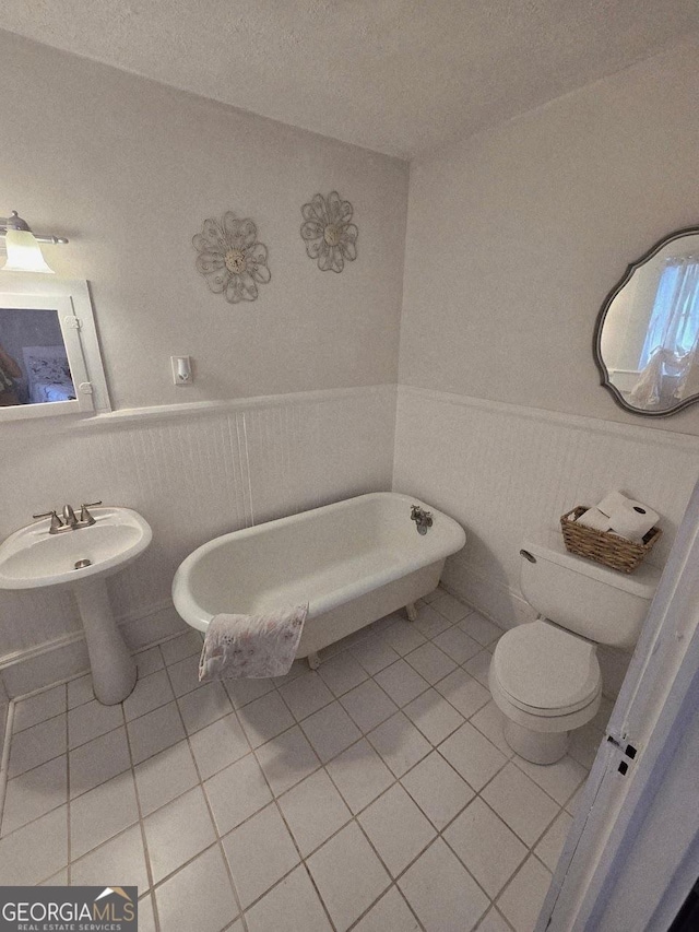 142 Griffin Dr, Carrollton, GA 30117 - full bath with tile patterned flooring, wainscoting, and a freestanding bath