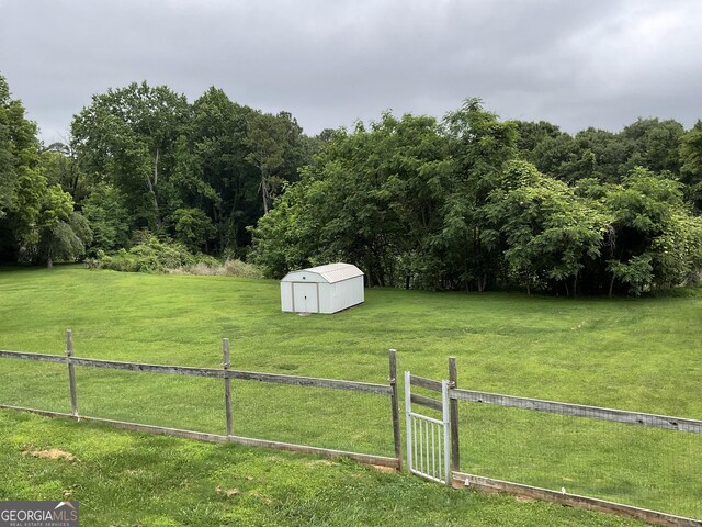 574 Lakeview Dr, Gainesville, GA 30501 - view of yard with a storage shed, a view of countryside, and a view of trees