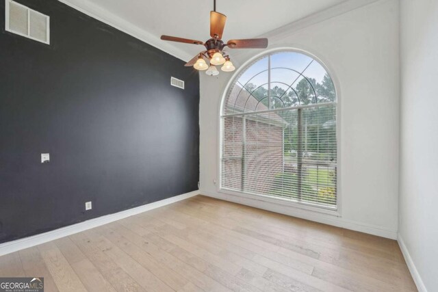 1535 Lake Dow Rd, Mcdonough, GA 30252 - spare room featuring healthy amount of natural light, wood finished floors, ceiling fan, and ornamental molding