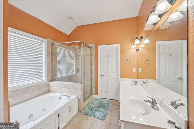 1535 Lake Dow Rd, Mcdonough, GA 30252 - full bath featuring tile patterned floors, a stall shower, a whirlpool tub, double vanity, and lofted ceiling
