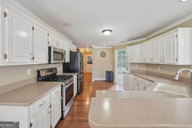 1535 Lake Dow Rd, Mcdonough, GA 30252 - kitchen featuring stainless steel appliances, white cabinetry, wood finished floors, ornamental molding, and light countertops