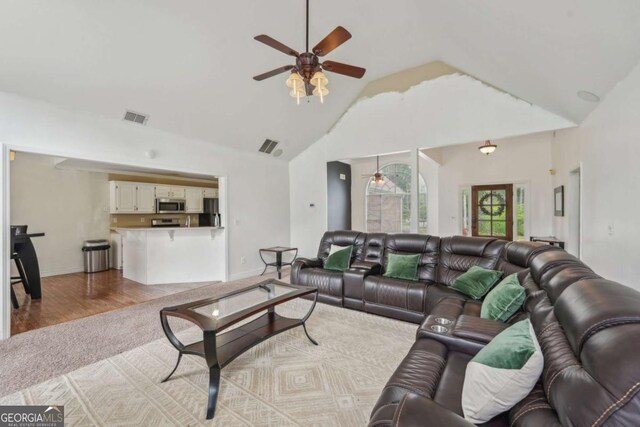 1535 Lake Dow Rd, Mcdonough, GA 30252 - living area with ceiling fan, light colored carpet, high vaulted ceiling, and light wood-type flooring