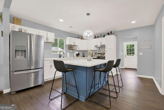 717 Morningside Dr, Dalton, GA 30721 - kitchen with appliances with stainless steel finishes, white cabinets, under cabinet range hood, light countertops, and plenty of natural light