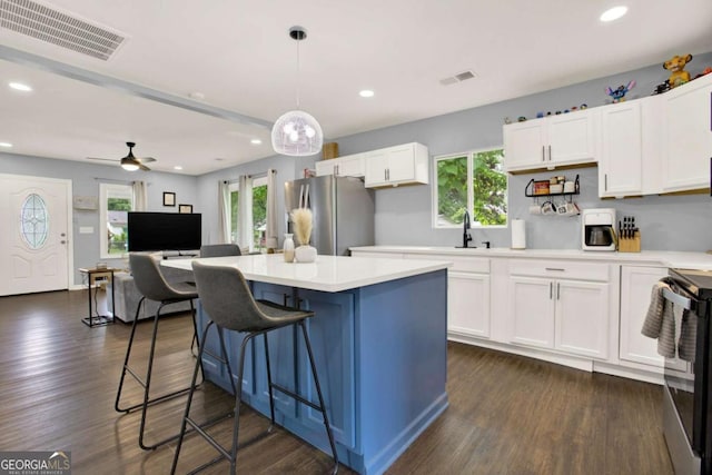 717 Morningside Dr, Dalton, GA 30721 - kitchen with appliances with stainless steel finishes, light countertops, white cabinetry, a kitchen breakfast bar, and recessed lighting