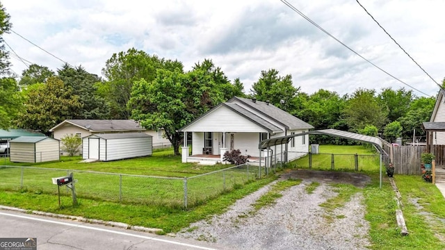 717 Morningside Dr, Dalton, GA 30721 - view of front facade with driveway, a porch, a storage shed, and a carport