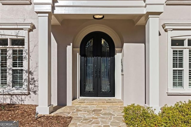 8610 Sentinae Chase Dr, Roswell, GA 30076 - view of exterior entry with french doors and stucco siding