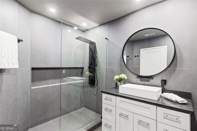 8610 Sentinae Chase Dr, Roswell, GA 30076 - full bathroom with vanity, a walk in shower, tile walls, and recessed lighting