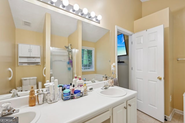 198 Lake Cv, Approach, Newnan, GA 30265 - full bathroom featuring double vanity, tile patterned flooring, a shower stall, and toilet