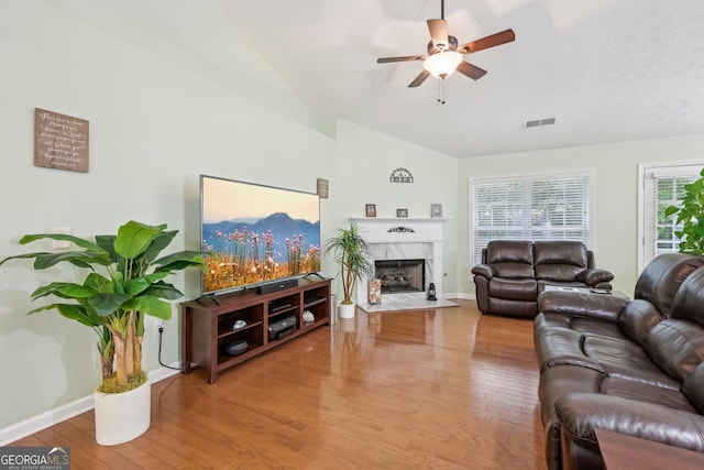 198 Lake Cv, Approach, Newnan, GA 30265 - living room with wood finished floors, ceiling fan, lofted ceiling, a premium fireplace, and baseboards