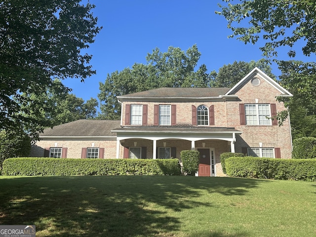 311 Arbor Point Ct SW, Lilburn, GA 30047 - view of front of home featuring brick siding, a front lawn, and a porch