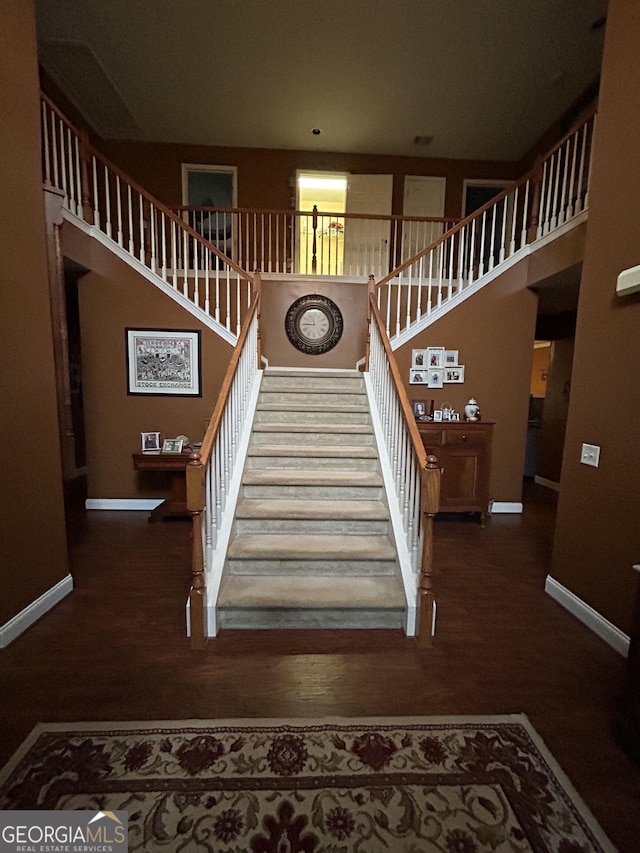 311 Arbor Point Ct SW, Lilburn, GA 30047 - stairs featuring baseboards and wood finished floors