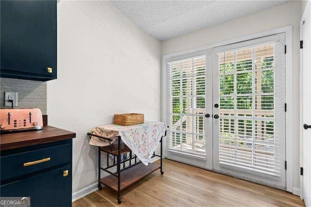 374 Dooley Rd, Dallas, GA 30132 - dining area with a textured ceiling, light wood-style floors, french doors, and baseboards