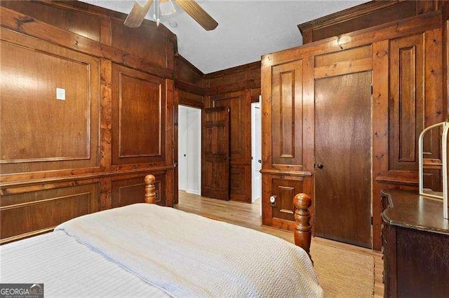 374 Dooley Rd, Dallas, GA 30132 - bedroom featuring vaulted ceiling, wood walls, light wood-style floors, and ceiling fan