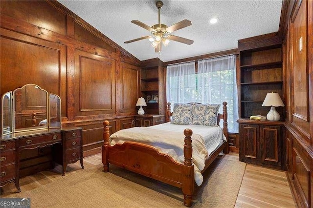 374 Dooley Rd, Dallas, GA 30132 - bedroom with a textured ceiling, vaulted ceiling, light wood-style flooring, wood walls, and crown molding