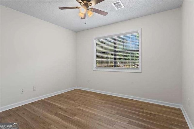 374 Dooley Rd, Dallas, GA 30132 - empty room featuring baseboards, ceiling fan, a textured ceiling, and wood finished floors