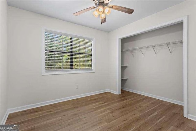 374 Dooley Rd, Dallas, GA 30132 - unfurnished bedroom with wood finished floors, a closet, baseboards, and a ceiling fan